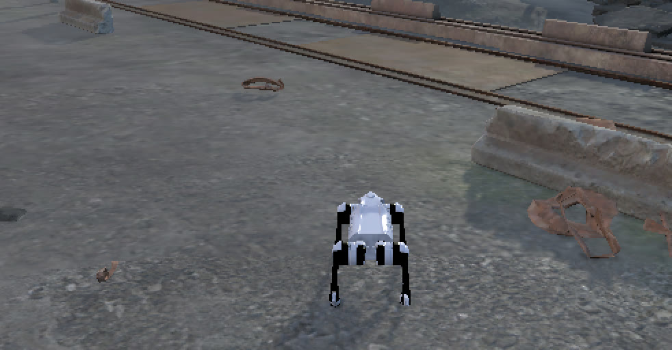 A quadruped robot on rough industrial ground beside rusty rails